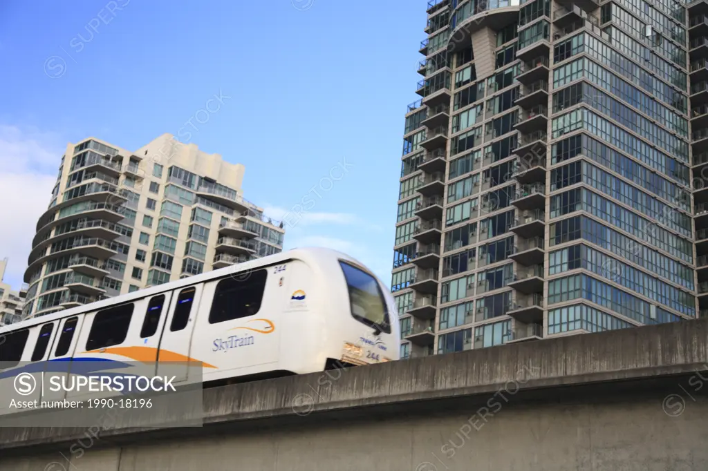 Skytrain light rapid transit with hi rise in background, Vancouver, British Columbia
