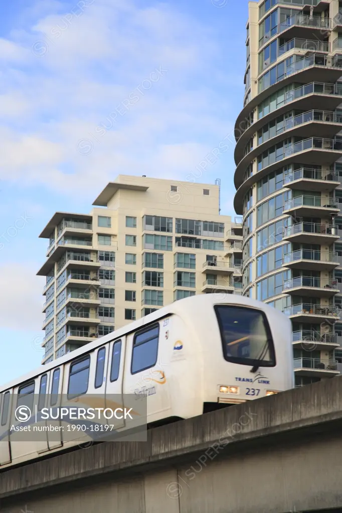 Skytrain light rapid transit with hi rise in background, Vancouver, British Columbia