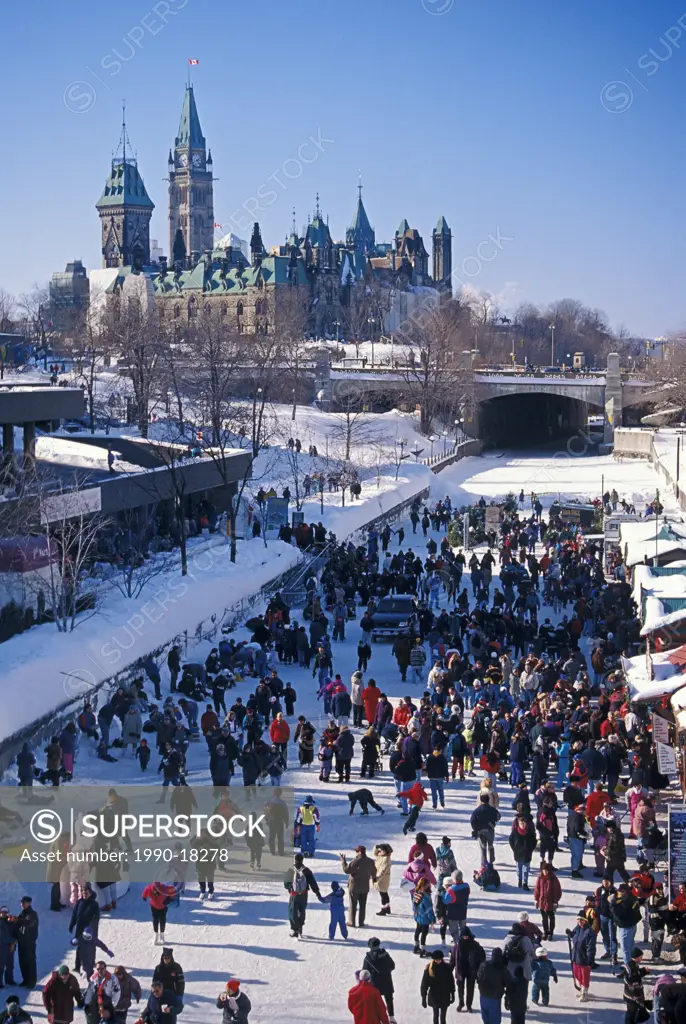 Skaters on Rideau Canal during Winterlude, Parliament Buildings in the background, Ottawa, Ontario, Canada