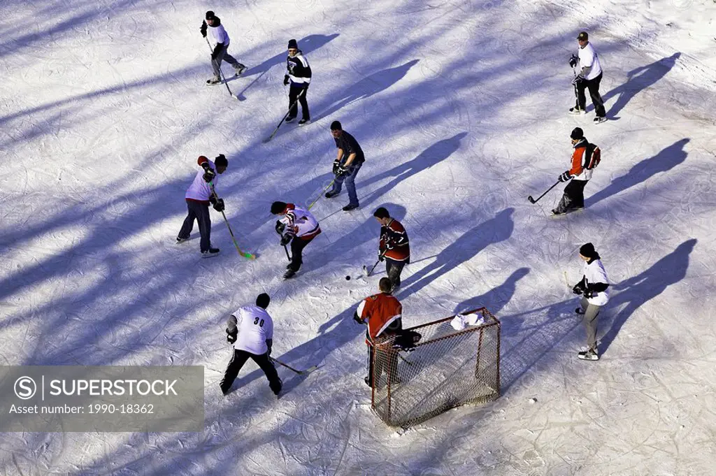 Playing old fashioned pond hockey on the Assiniboine River, at The Forks, Winnipeg, Manitoba, Canada.