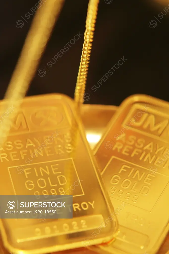 One ounce gold bars in tray of balance scales