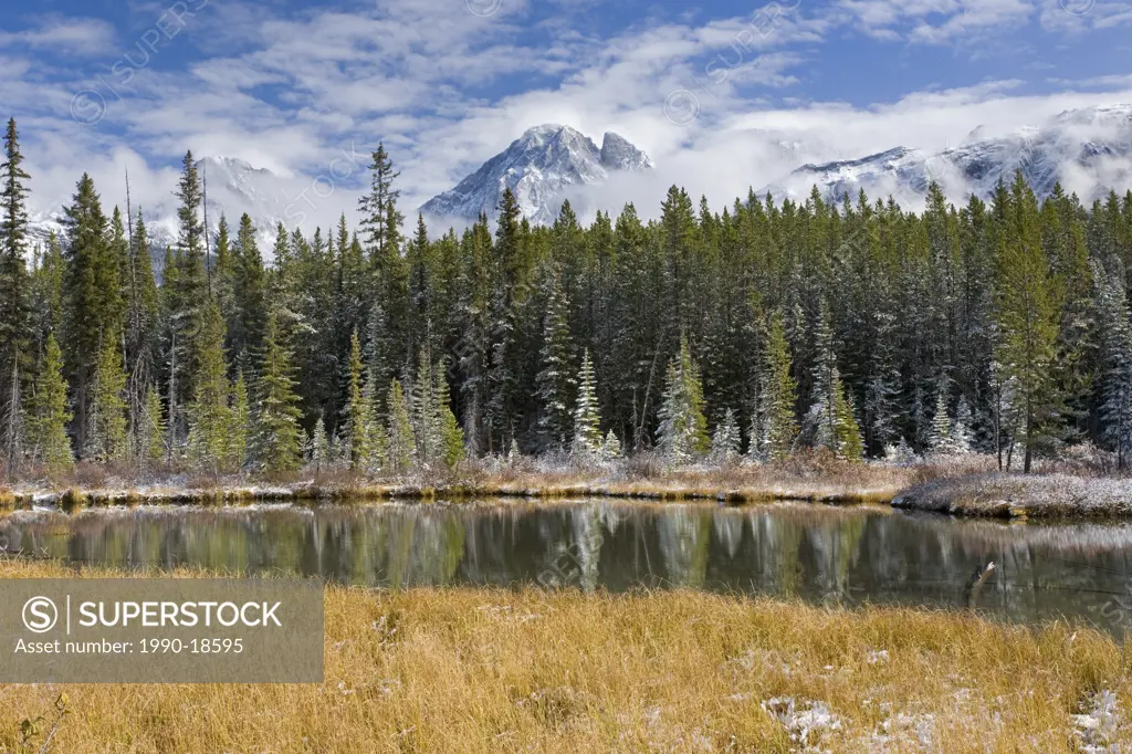 A fall afternoon at Spillway Lake looking to the Opan Range in the Canadian Rocky Mountains in Peter Lougheed Provincial Park in Kananaskis Country, A...