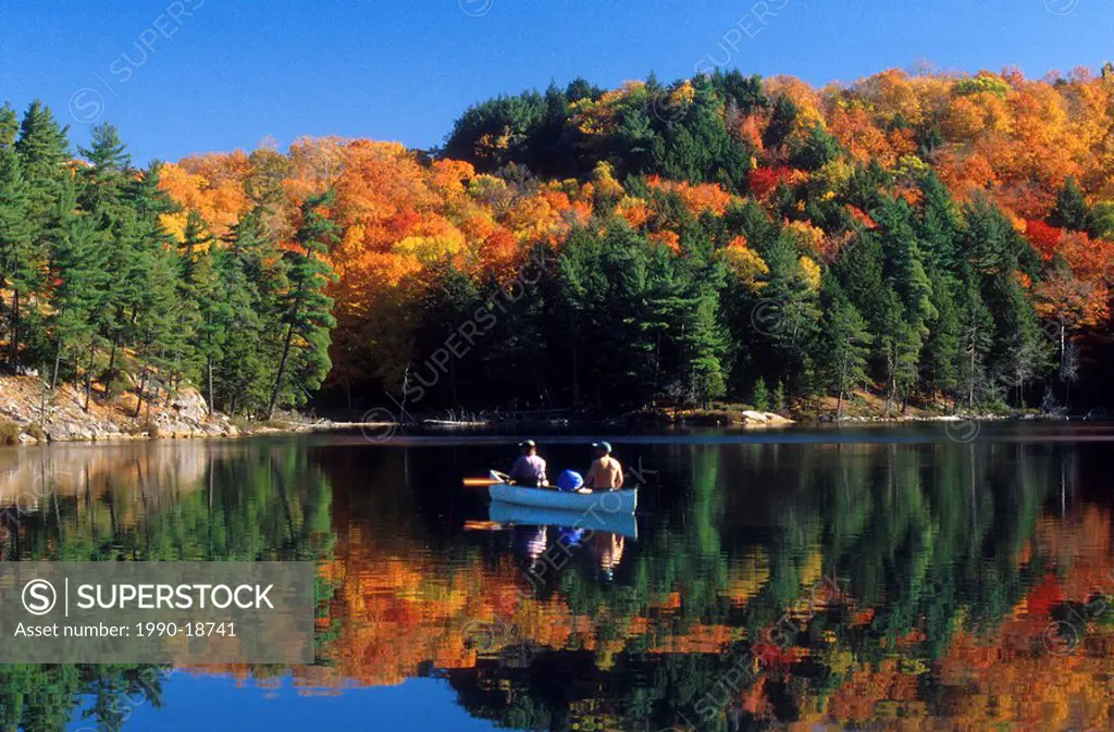 Fall canoeing on O.S.A Lake, Killarney Provincial Park, Ontario, Canada