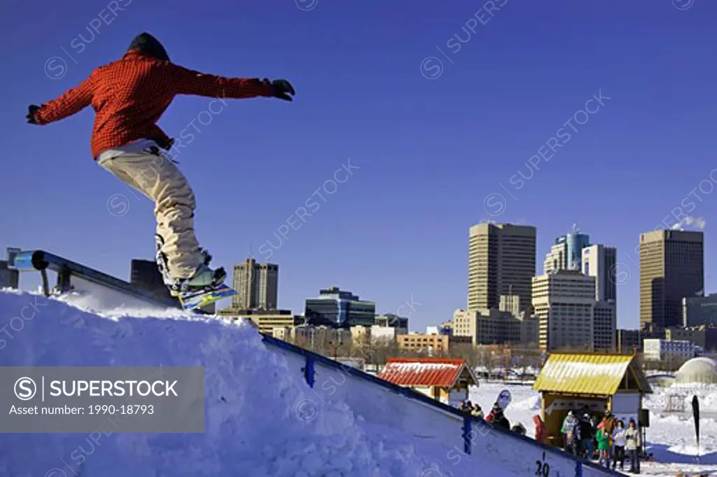 Teenage male snowboarder at The Forks Winter Park, Winnipeg, Manitoba, Canada