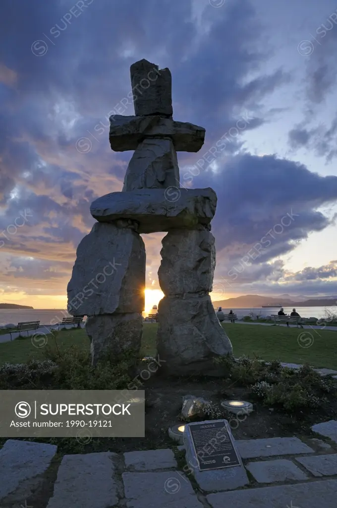 Inuit sculpture, Inukshuk, with dramatic cloud backdrop, English Bay, Vancouver, British Columbia, Canada