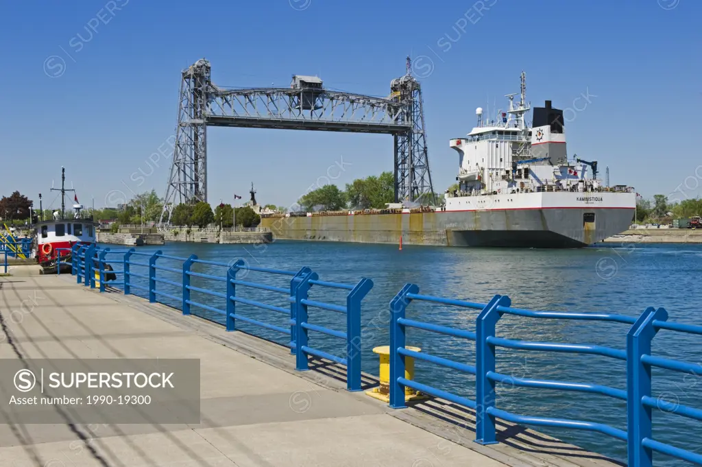 Great Lakes freighter enters the Lake Erie terminus of the Welland Ship Canal , en route to Lake Ontario, the Clarence Street Lift Bridge alongside th...