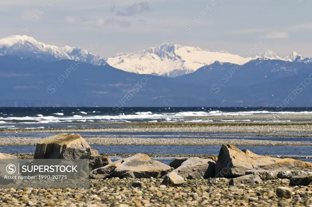 BC´s Mainland Coast Mountains tower over the beach at Parksville, on Vancouver Island.