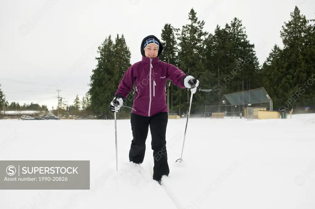 A woman cross country skiing in a park in Central Saanich near Victoria BC.