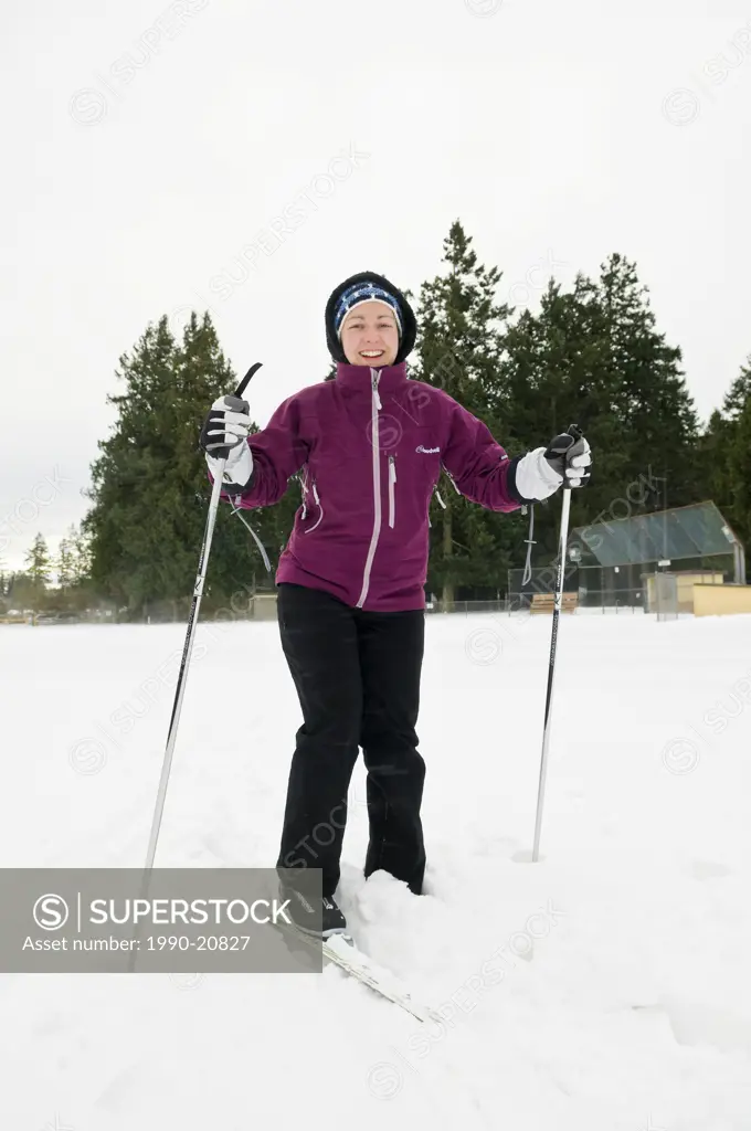 A woman cross country skiing in a park in Central Saanich near Victoria BC.