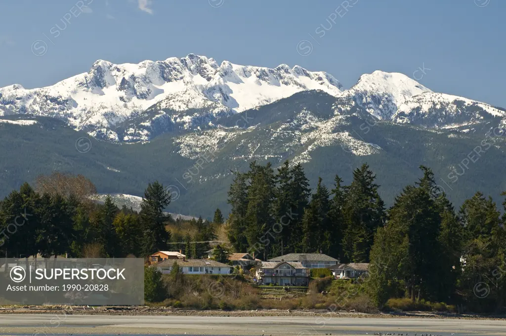 Snow_capped Mount Arrowsmith looms over the beach at Parksville BC.