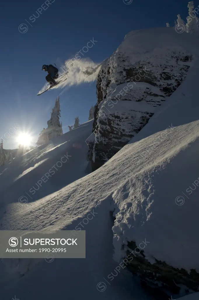 A Skier jumps a cliff while skiing in the backcountry of Fernie B.C