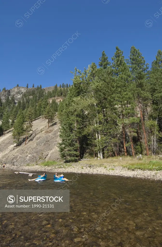 People float down the Kettle River at Kettle River Provincial Park, BC, Canada