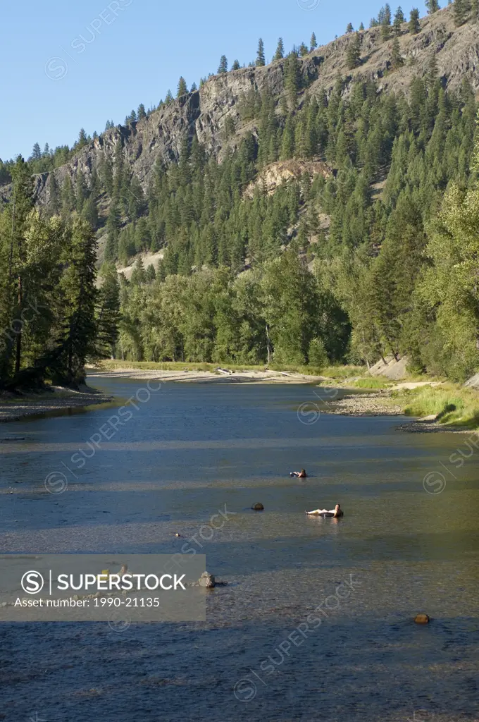 People float down the Kettle River at Kettle River Provincial Park, BC, Canada