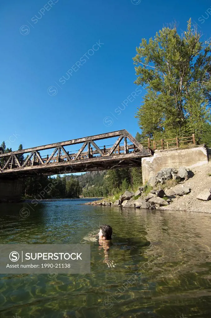Woman swimming at Kettle River Provincial Park, BC, Canada