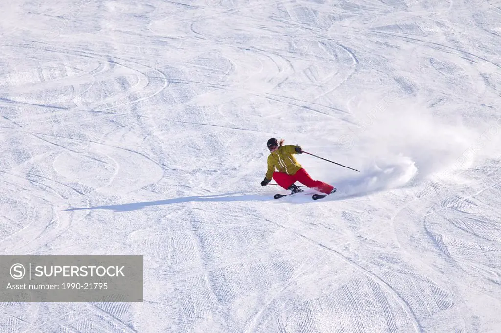 Young female skier carving turns at Sunshine Village Ski Resort