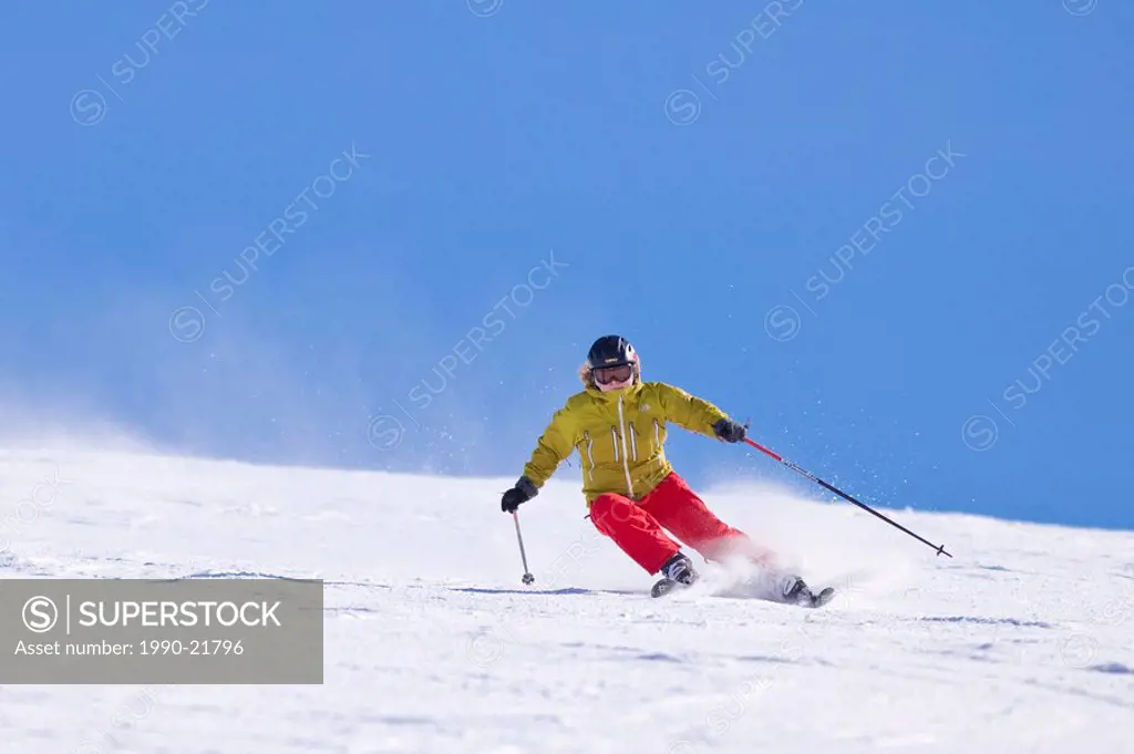 Young female skier carving turns at Sunshine Village Ski Resort