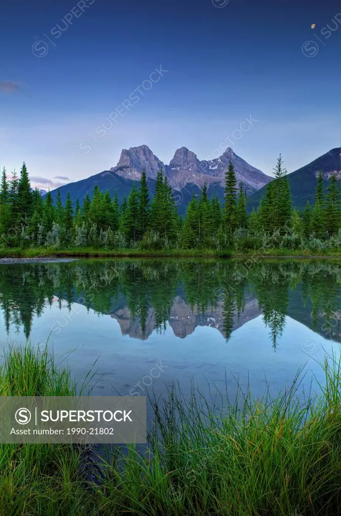 Three Sisters Mountain reflecting in water, Canmore, Alberta, Canada