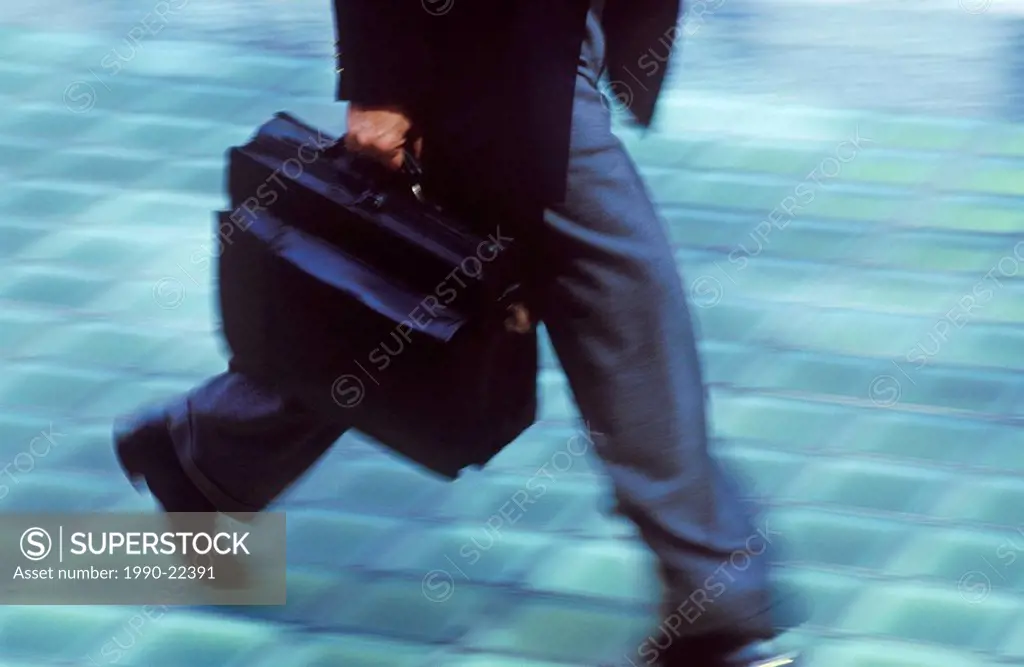 Business man walking with brief case, British Columbia, Canada