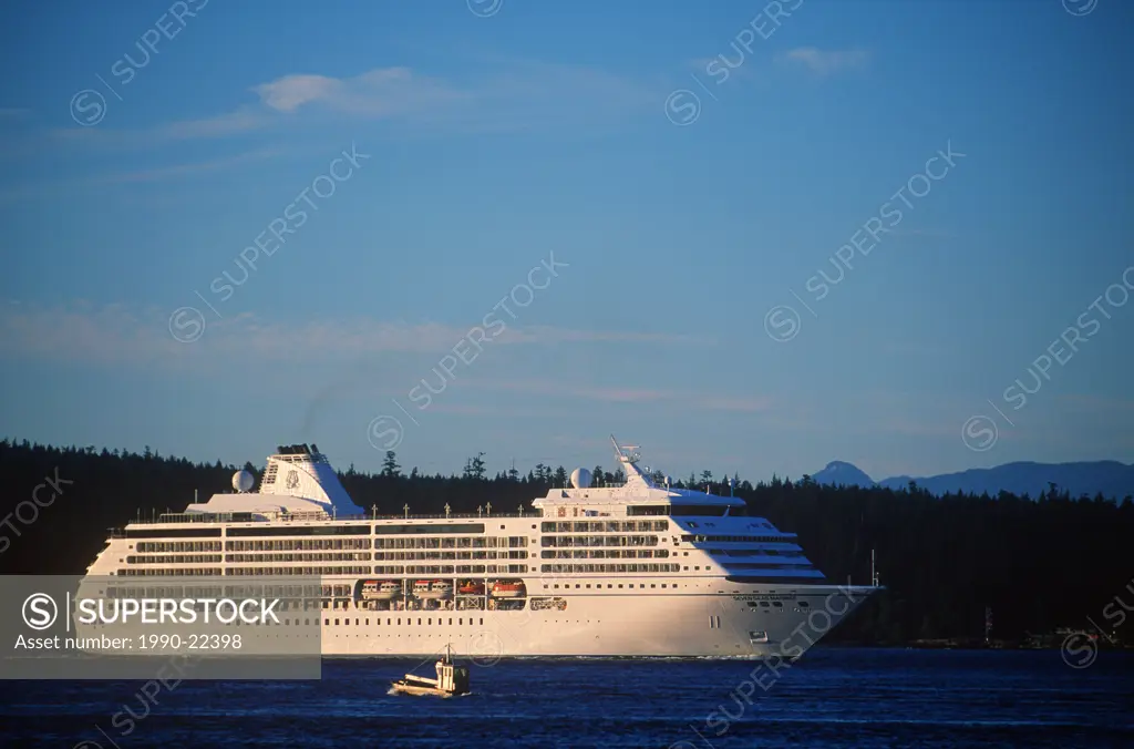 Passenger cruise ship in Johnstone Stait, near Campbell River, Quadra Island behind, British Columbia, Canada