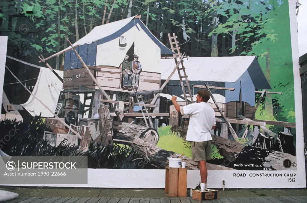 Artists repairs his mural, Chemainus town of murals, Vancouver Island, British Columbia, Canada