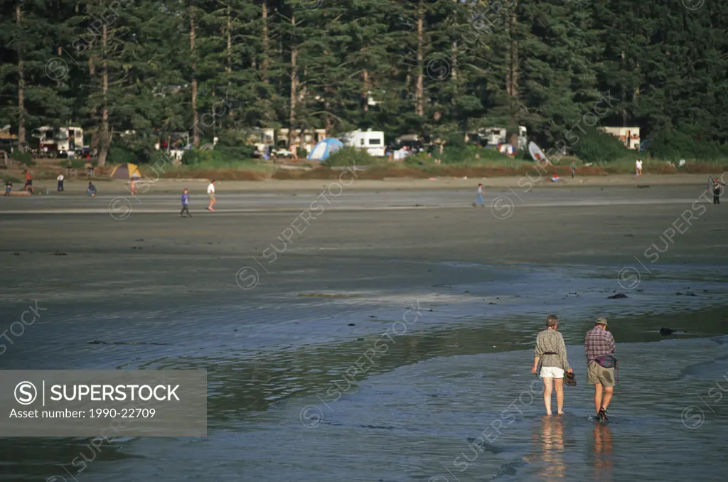MacKenzie Beach campers walk on beach, Tofino, Vancouver Island, British Columbia, Canada