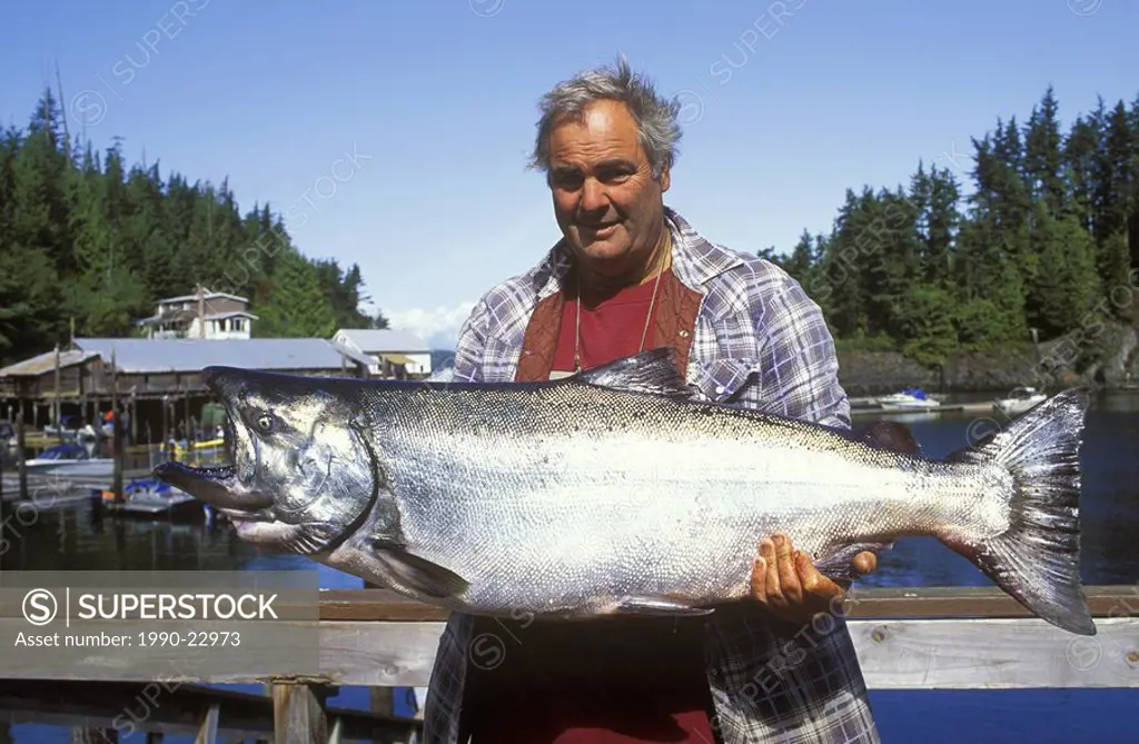 Ocean fishing, angler displays 55 lb  chinook salmon catch, Vancouver Island, British Columbia, Canada