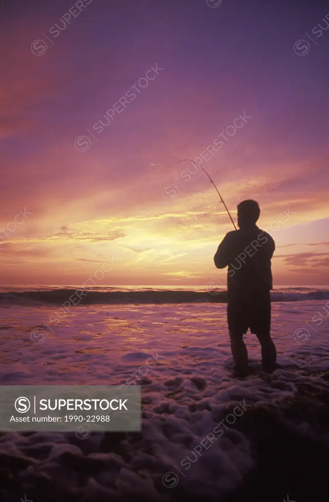 Ocean fishing, angler fishes at sunset, British Columbia, Canada