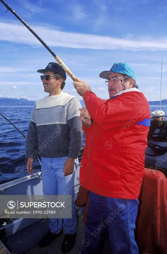 Salmon fishing, angler plays salmon, British Columbia, Canada