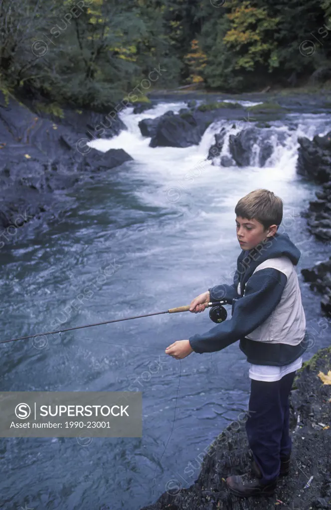 Cowichan River, young boy fishes pool, Vancouver Island, British Columbia, Canada