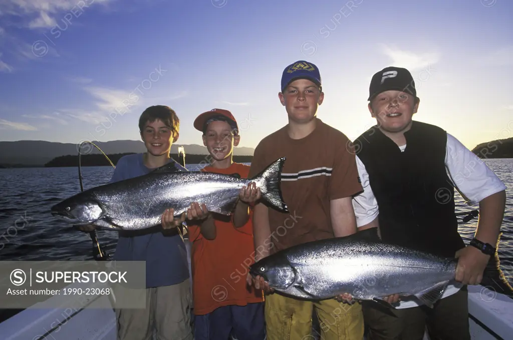 boys proudly display fresh caught chinook salmon, Vancouver Island, British Columbia, Canada
