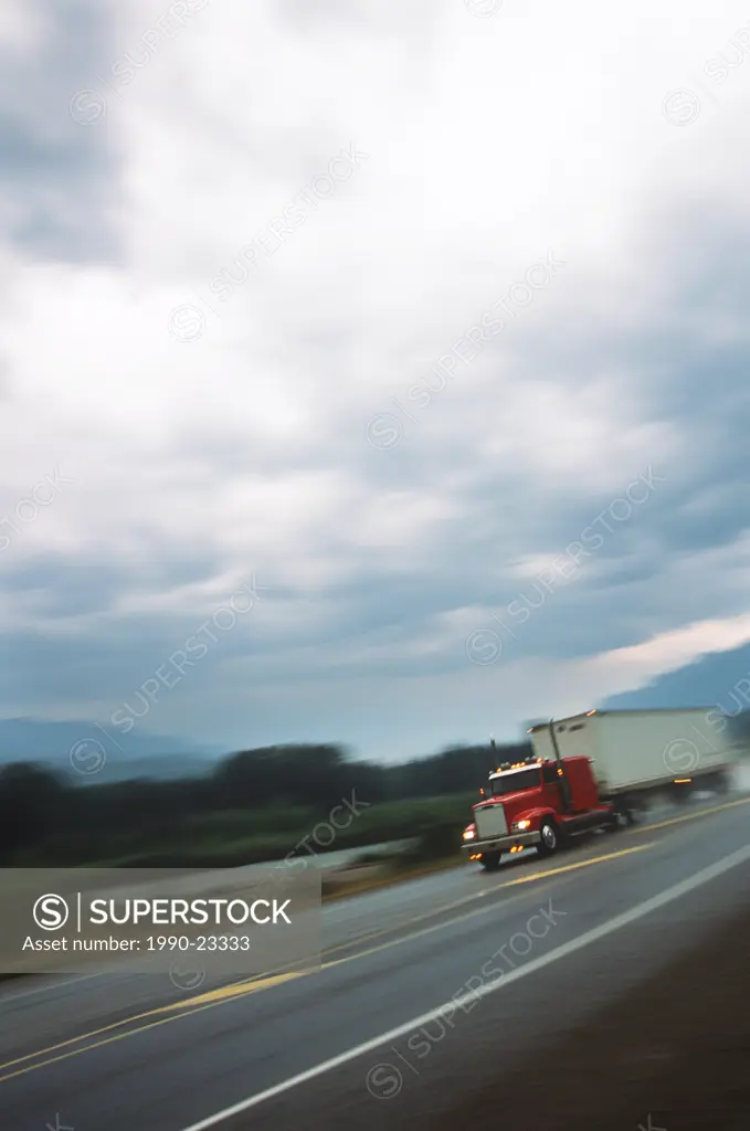 Blurred shot of transport truck on highway, British Columbia, Canada
