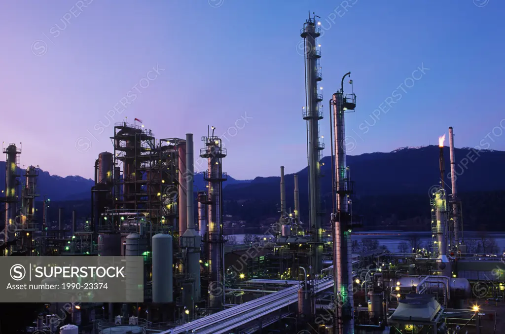 Oil refinery in Burnaby, North Shore mountains beyond, Vancouver, British Columbia, Canada