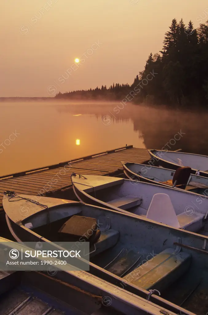 Boats at sunrise, childs lake, duck mountain Provincial Park, manitoba, Canada