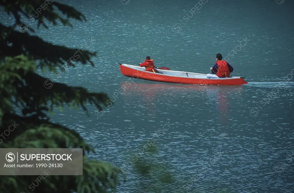 Father & son in red canoe on Emerald Lake, British Columbia, Canada