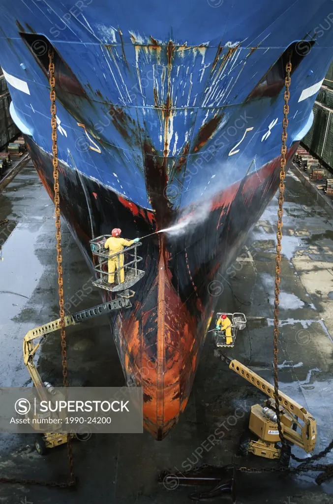 shipyard workers power wash hull of ship, Victoria, Vancouver Island, British Columbia, Canada