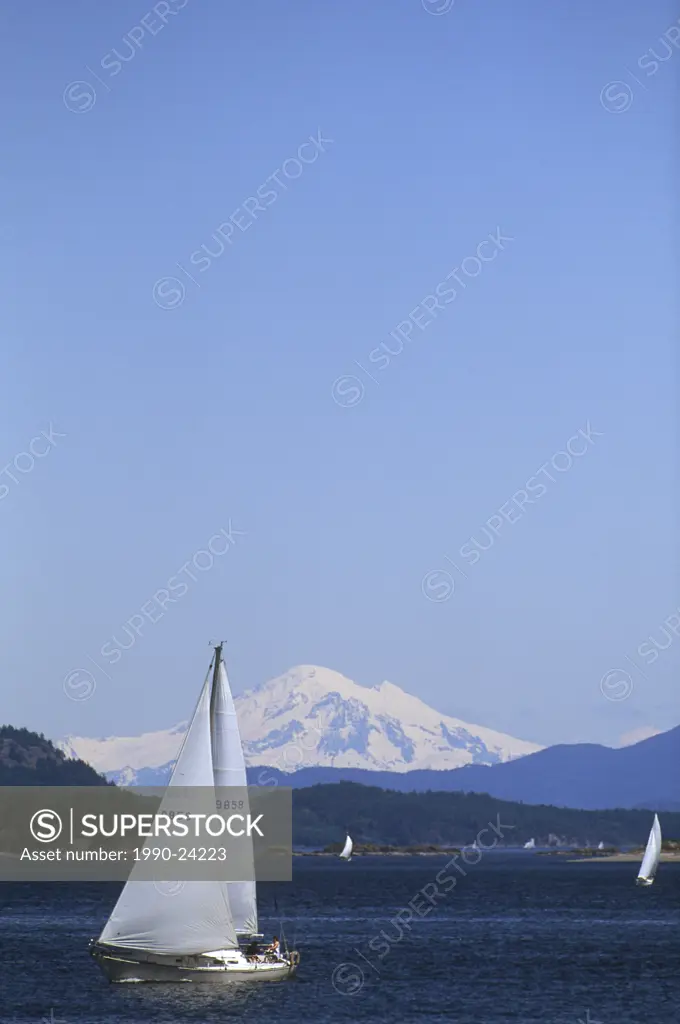 Sidney waterfront, sloop and Mt Baker, Vancouver Island, British Columbia, Canada