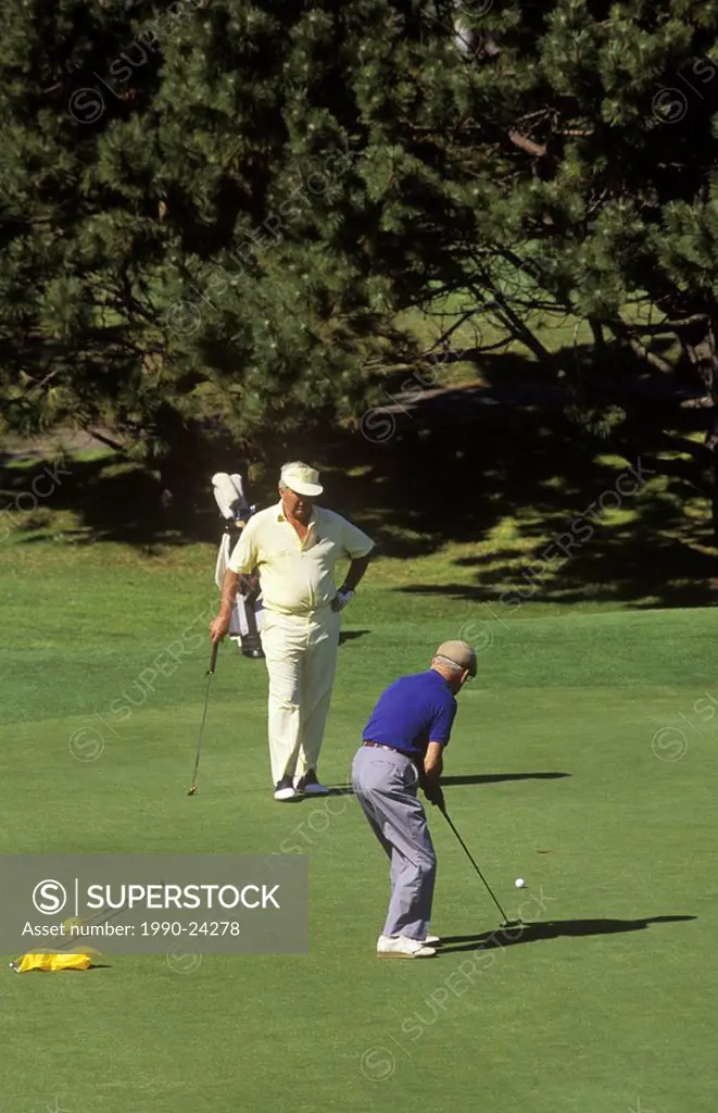 Retired men on golf course, British Columbia, Canada