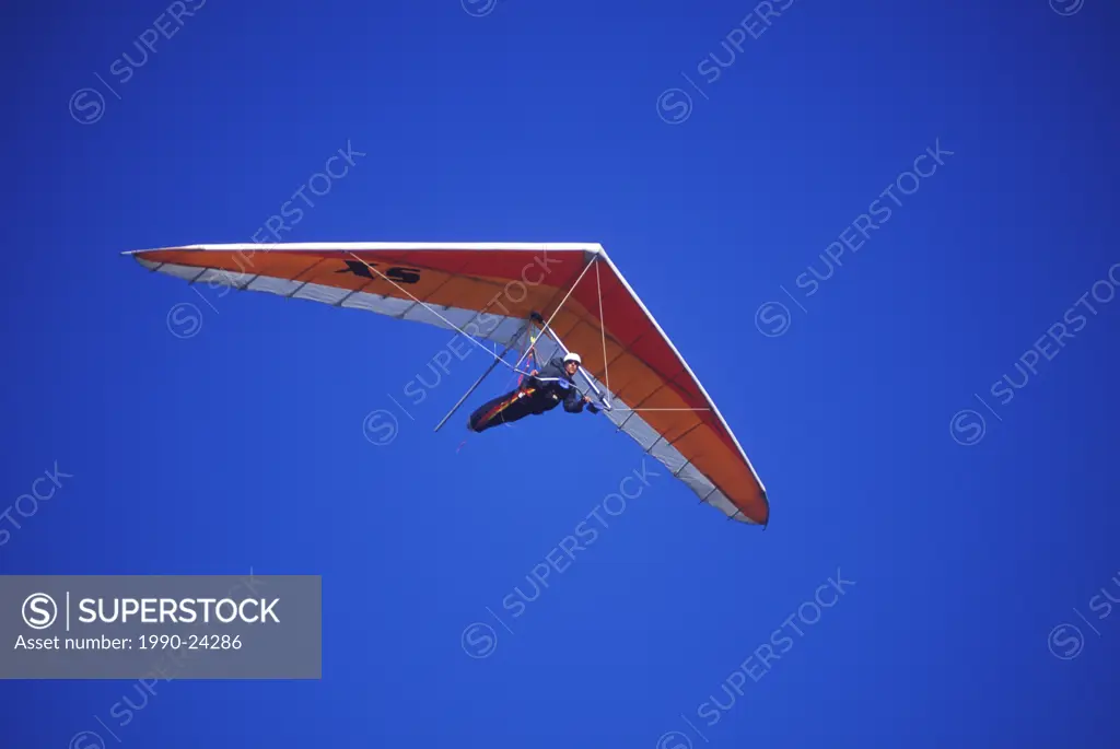 Hang glider in flight on blue sky, British Columbia, Canada