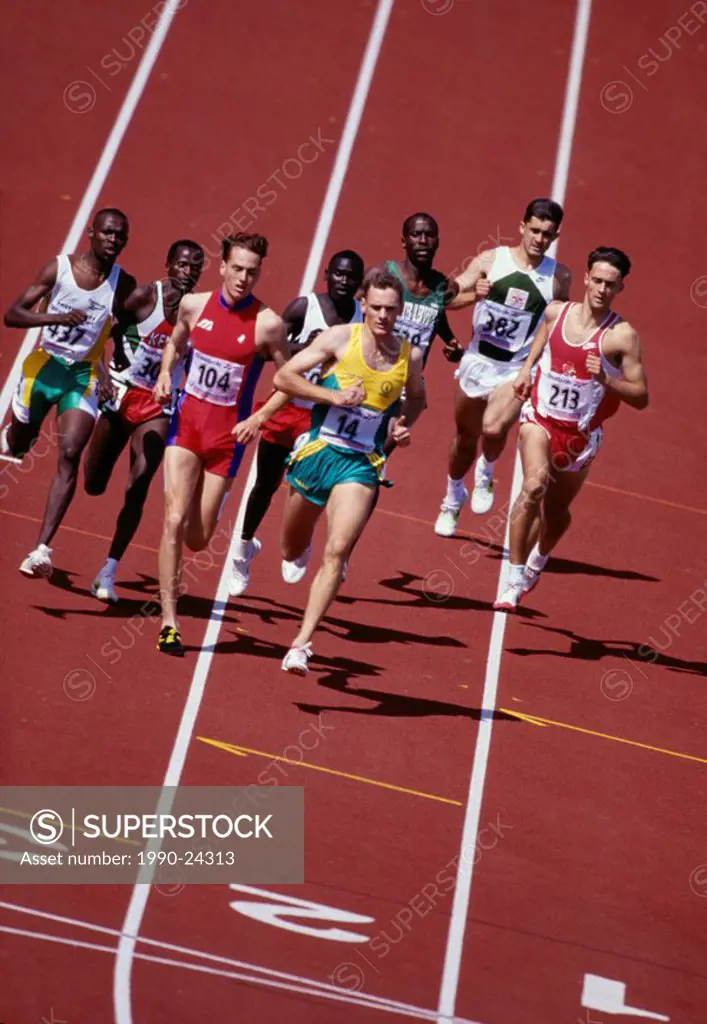 Middle distance runners on rust track in group, British Columbia, Canada