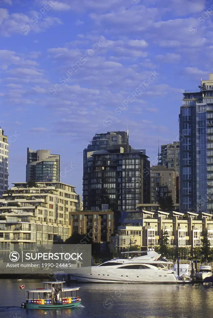 Morning view across False Creek to Concord Pacific condominiums with small harbour ferry, Vancouver, British Columbia, Canada