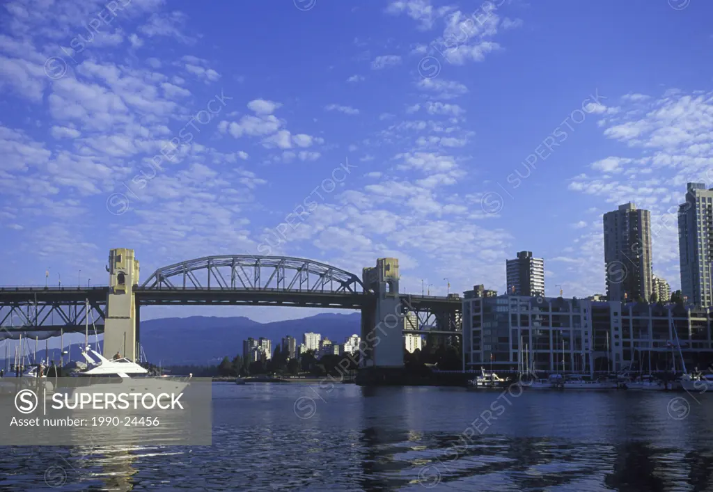 Burrard bridge frames view to West End, with yacht underway, Vancouver, British Columbia, Canada