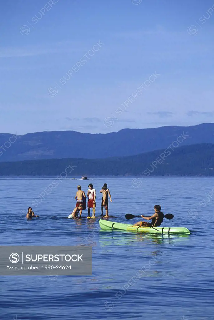 Qualicum Beach Kids at play in ocean waters, Vancouver Island, British Columbia, Canada