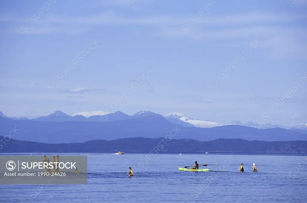 Qualicum Beach Kids at play in ocean waters, Vancouver Island, British Columbia, Canada