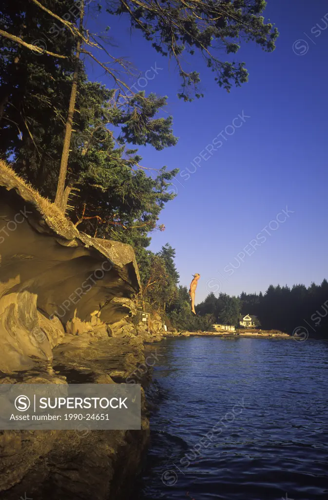 Malaspina Galleries, Gabriola Island, Young girl jumping from sandstone ledge, Vancouver Island, British Columbia, Canada