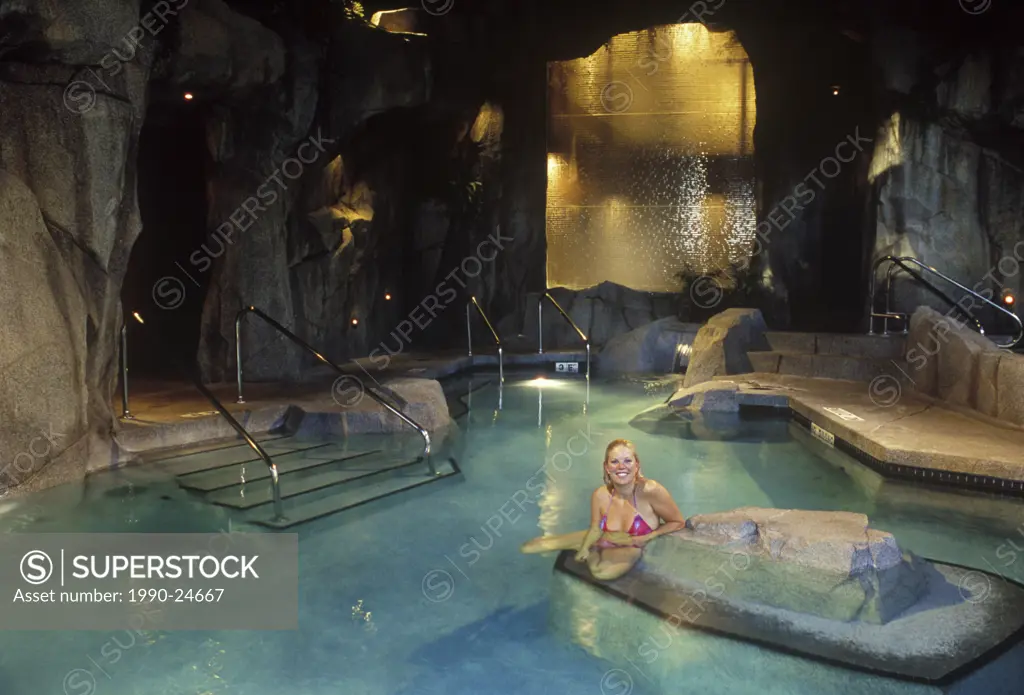Woman enjoying pools area at the ´Grotto´ Spa, Tigh-Na-Mara resort at Parksville, Vancouver Island, British Columbia, Canada