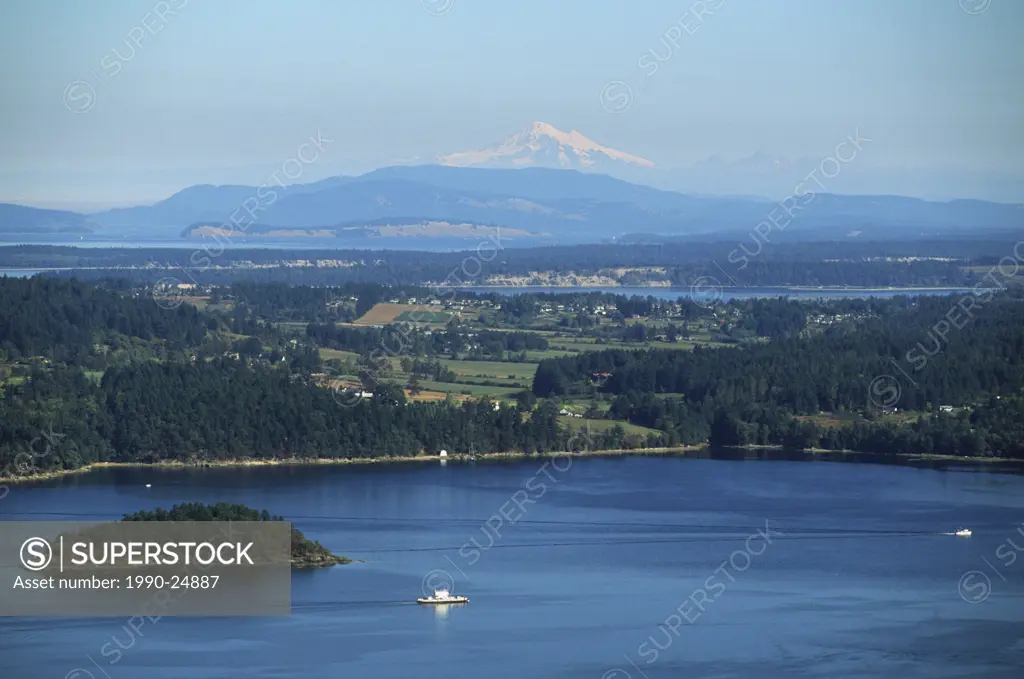 Mill Bay ferry sailing past Saanich Peninsula with Mt  Baker beyond, Victoria, Vancouver Island, British Columbia, Canada