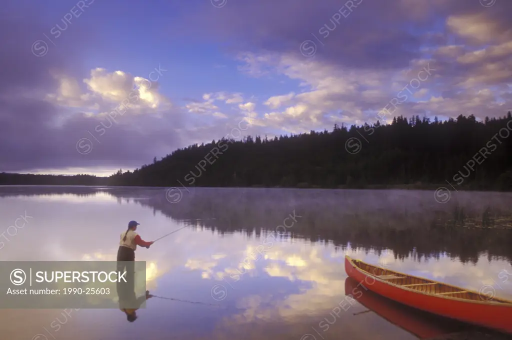 Fly-fishing at dawn on 108 Mile Lake, British Columbia, Canada
