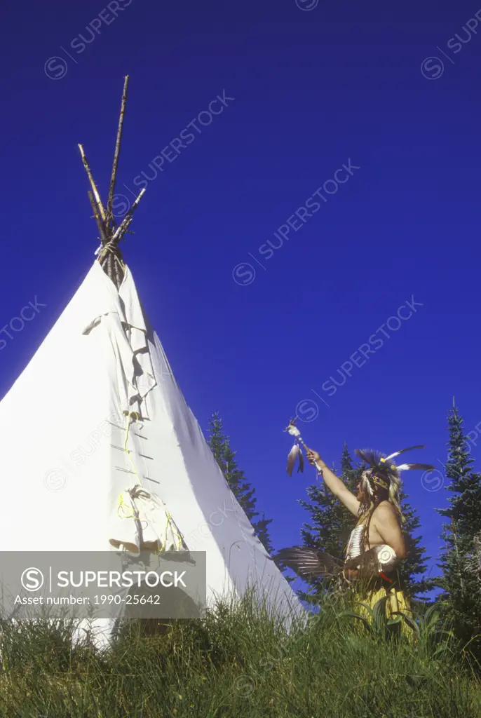First Nations men in Indigenous regalia by their Tipi, British Columbia, Canada