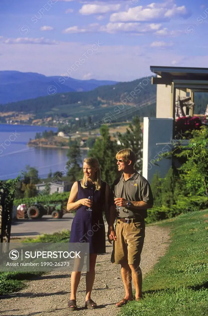 Couple walking in vineyards at Gray Monk Winery, Okanagan Centre, British Columbia, Canada