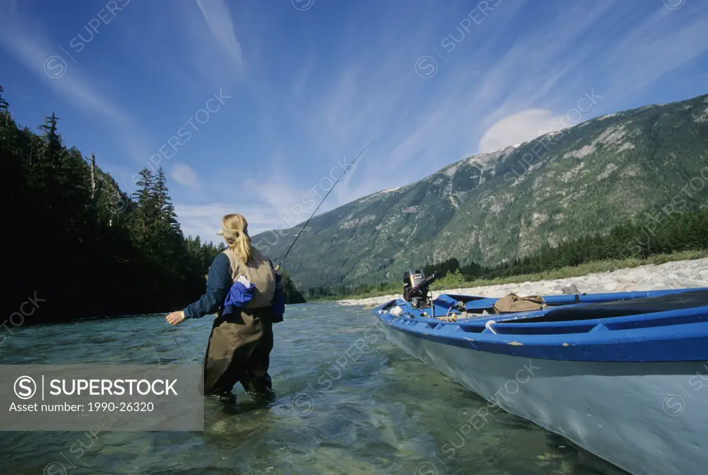 Lady flyfisher fishing for steelhead, Dean river, British Columbia, Canada
